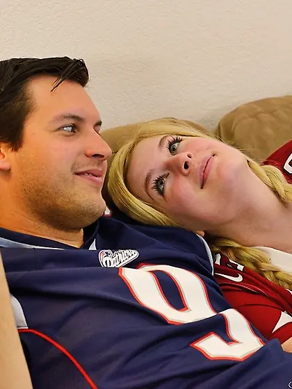 Football loving couple enjoy