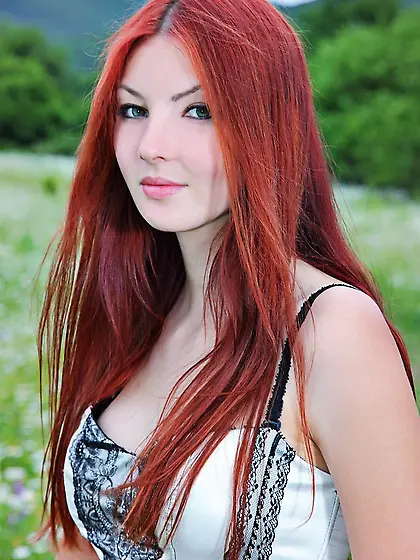 Lusty redhead uninhibited and seductive outdoors.