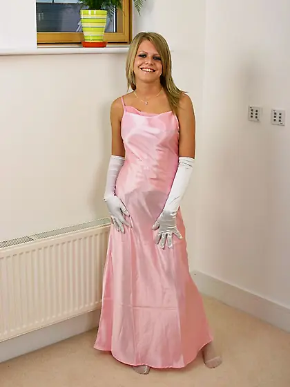 Sammy Jo in long white gloves wears long pink dress that hides h