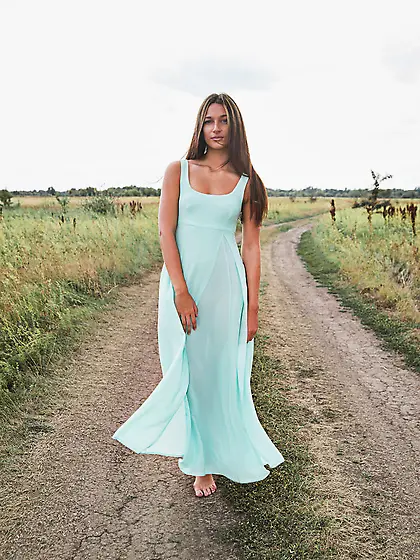 Chick in turquoise dress flashes breasts and cunt on the village