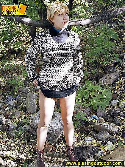 Pissing teen walks and pisses outdoor