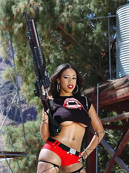 Dark skinned busty woman Amber Fox in red shorts and sexy top po