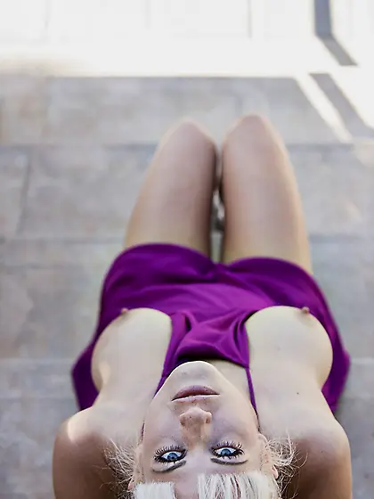 Fair-haired hottie in a purple dress flashes her pussy on the st