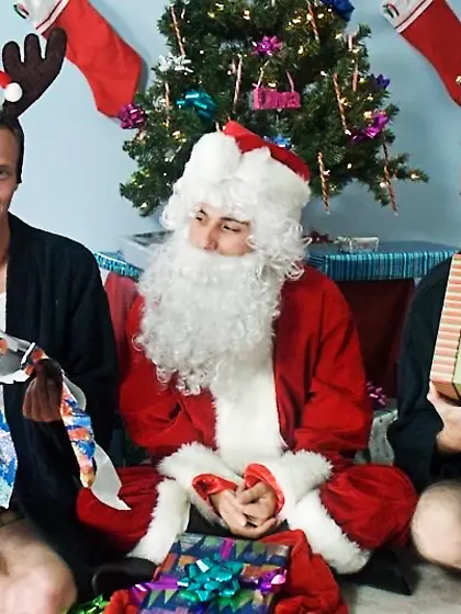 Gay dressed santa brings