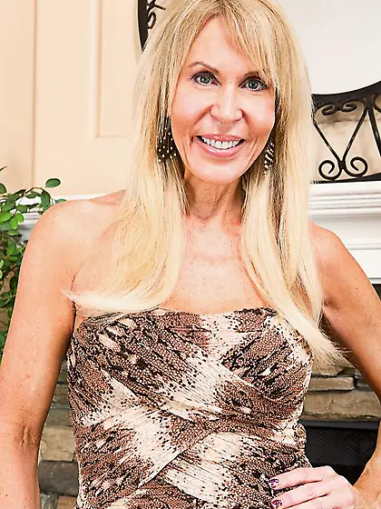 Blond milf Erica Lauren is touching her big boobs and licking th