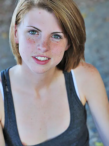 Professional pleaser with short hair and cute face shows her sma