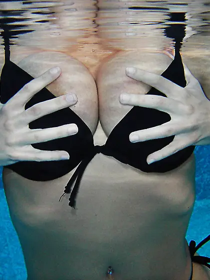 Busty teen model Sweet Krissy takes off her bikini in the pool a