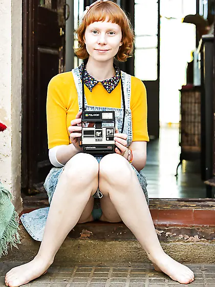 Young redhead female shows off hairy hole in the garden with no