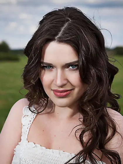 Pale-skinned brunette posing completely naked in the middle of n