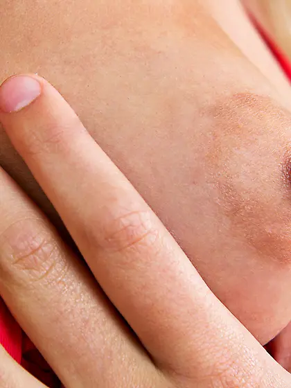 Skinny young lady takes off her red outfit and starts to rub tha