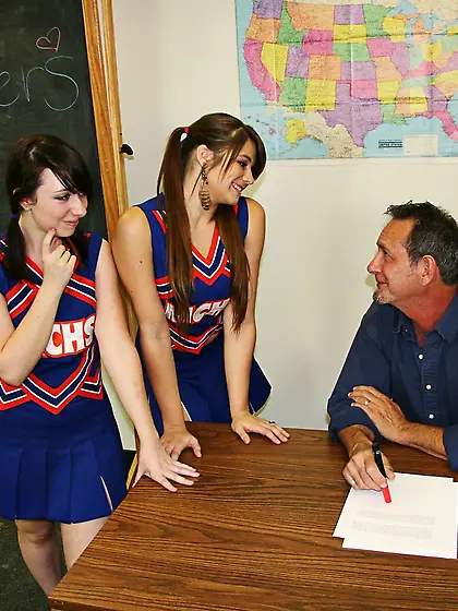 Teen cheerleaders satisfying teacher