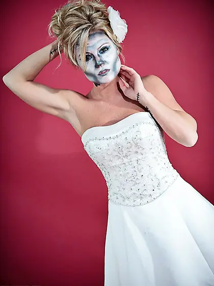 Blonde babe with painted face Meet Madden poses in a wedding dre