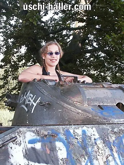 Teen Nathalie poses on an old Hotchkiss APC