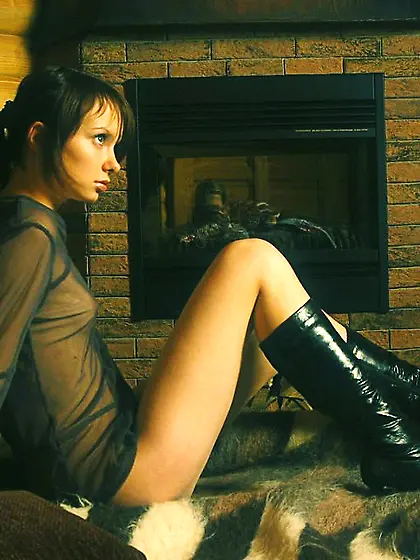 Dark-haired beauty in a see-through outfit shows her goodies for