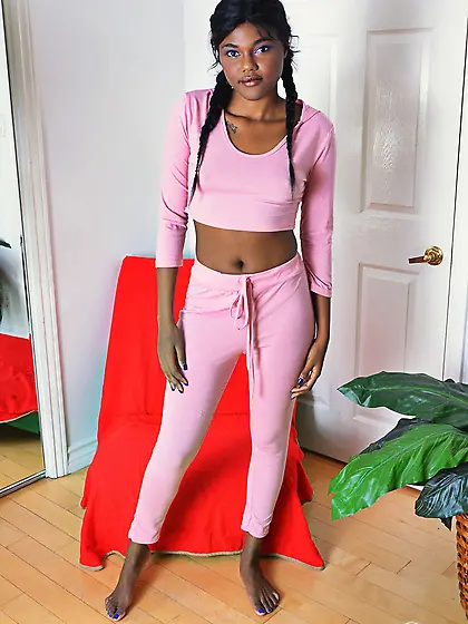 Black girl in pink pulls her pants down opening her bottom and m