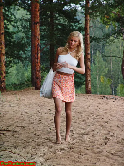 Blonde teen pissing in the beach