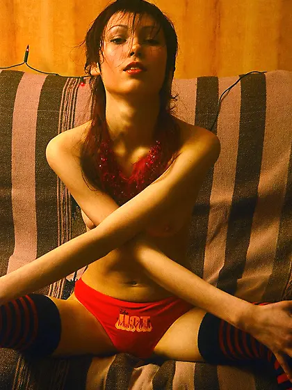 Mystical and enchanting scrawny brunette posing in an empty room