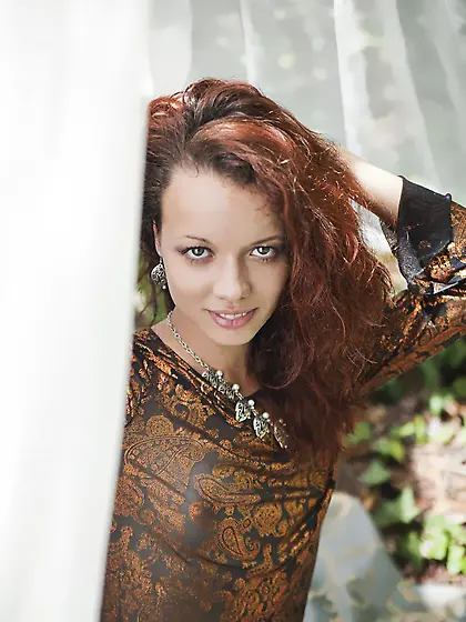 Korica A enjoys nice weather in the nature by taking off her clo