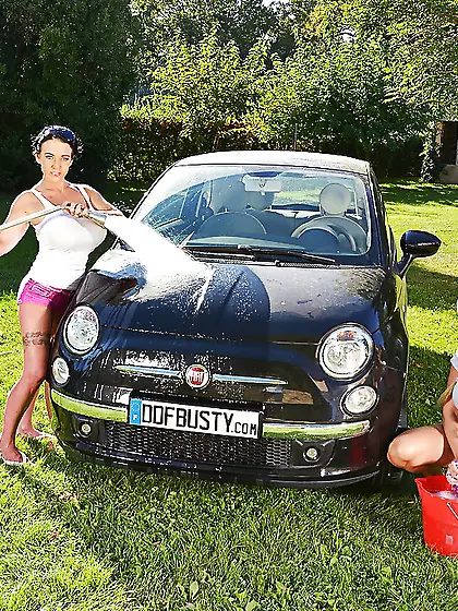 Sexy busty MILFs wash small car and their huge tits under white
