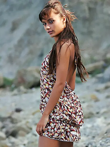 Dark-haired and vaguely exotic beauty stripping on the shore Vid