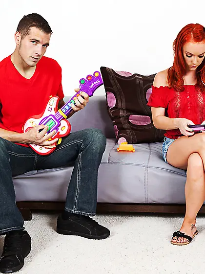 Foxy redhead chick Dani Jensen strips on the bed and gets fucked