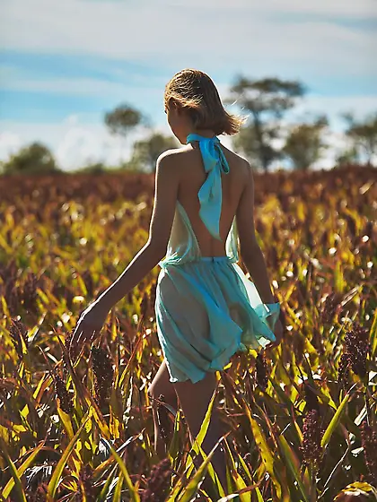 Romantic young blonde poses naked outdoors