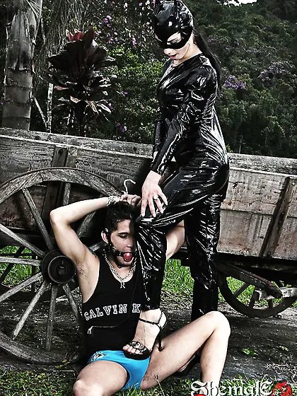 Catsuit shemale mistress abuses her slave boy