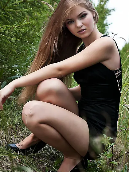 Sweet blonde teen Bridgit A is hiding in the bushes and exposing