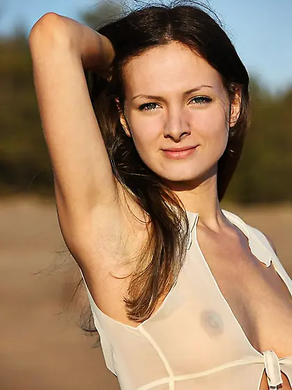 Beautiful babe Zhanet A has climbed the huge stone to show the n