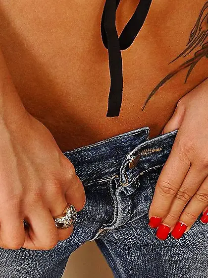 Great looking blonde babe takes off her blue jeans and displays