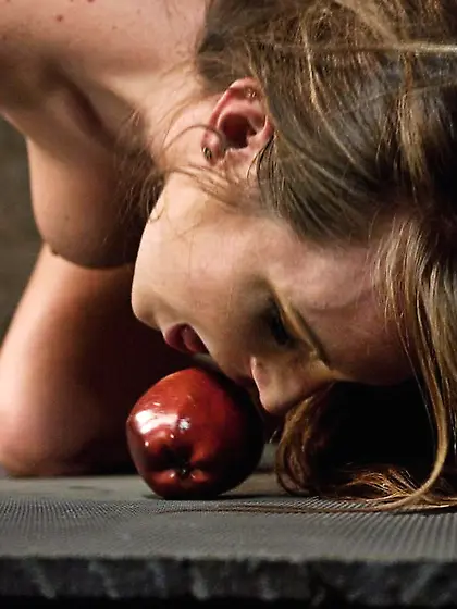 Tied bitch eats apple