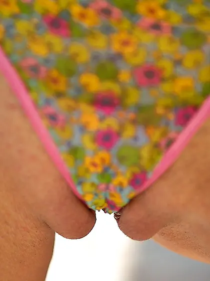 Colorfully dressed blonde fucking her own slit with a glass toy