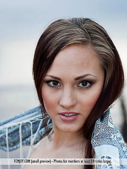 Seducing babe Ella K is posing outdoor demonstrating shaved puss