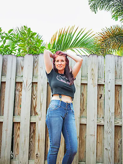 Sexy red-haired MILF takes off everything and poses all naked by