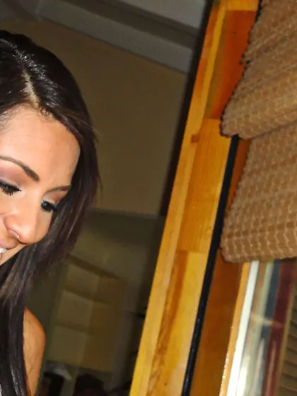 Tanned brunette in g-string gets her stunning body oiled and her