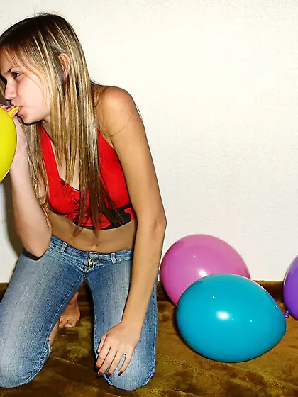 With her long blonde hair Katrina Nubiles blows up balloons and