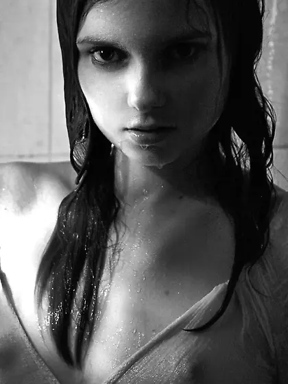 Brunette showing her small boobies in a black and white solo gal