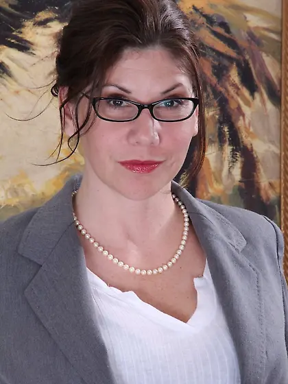 Glasses-wearing MILF takes off her teacher-like outfit on camera