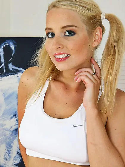 Cute pigtailed blonde playing with a sex toy and her boobs