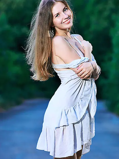 Dress-wearing brunette gets naked on a deserted mountain road Vi