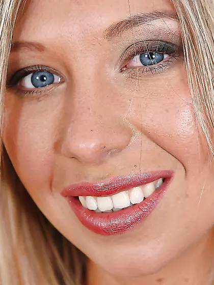 Solo pictures of a blue-eyed blonde woman in purple dress and bl