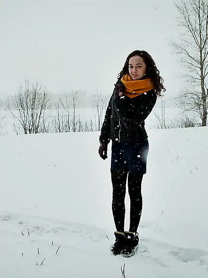 Curly-haired chick with a bushy pussy posing naked on a sofa Vid