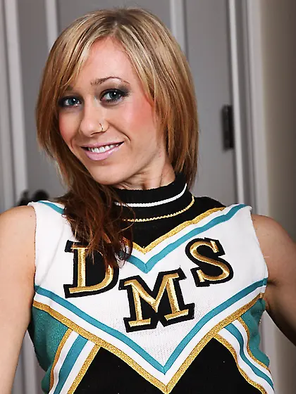 Cheerleader Naomi Doll gets naked and gives a close-up of her ba