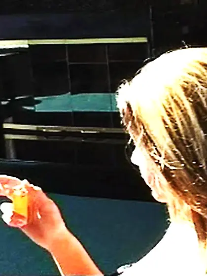 Sexy chick in a bra smoking a cigarette with...