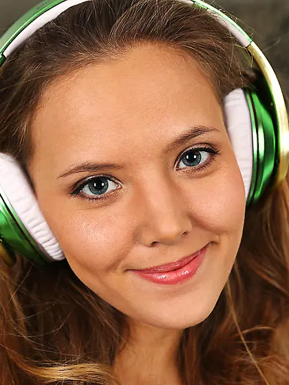 Green skirt brown-haired hottie undressing in front of a mirror