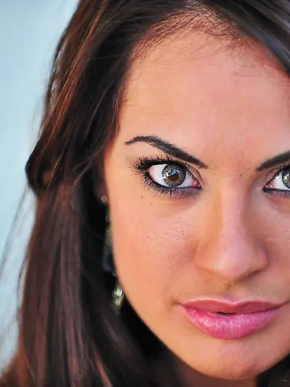 Cheery brunette in a sexy dress tries to seduce the camera with