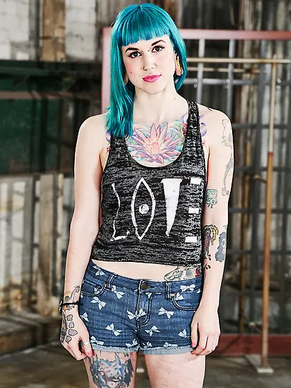 Babe with blue hair in striped stockings has a tattooed body to