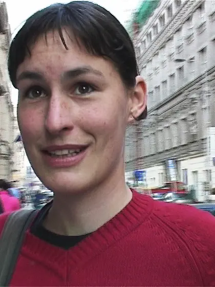 Ponytailed brunette teen blowing