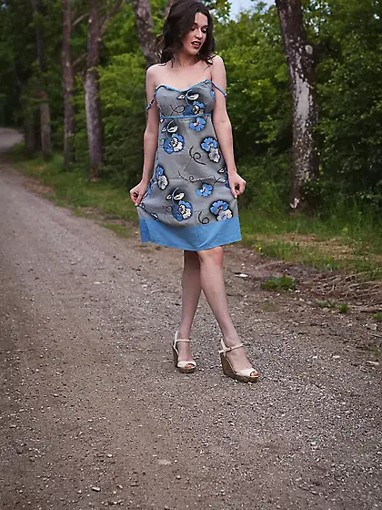 Dress-wearing brunette shows her natural breasts on a lonely for