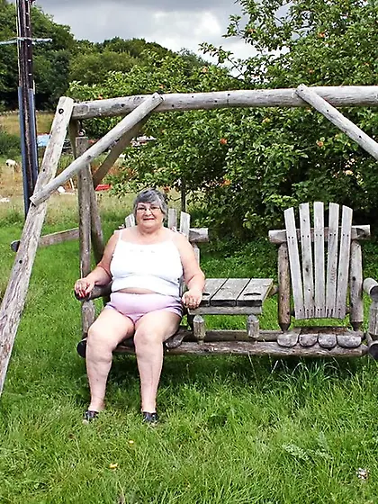 Fat grandma sits wooden